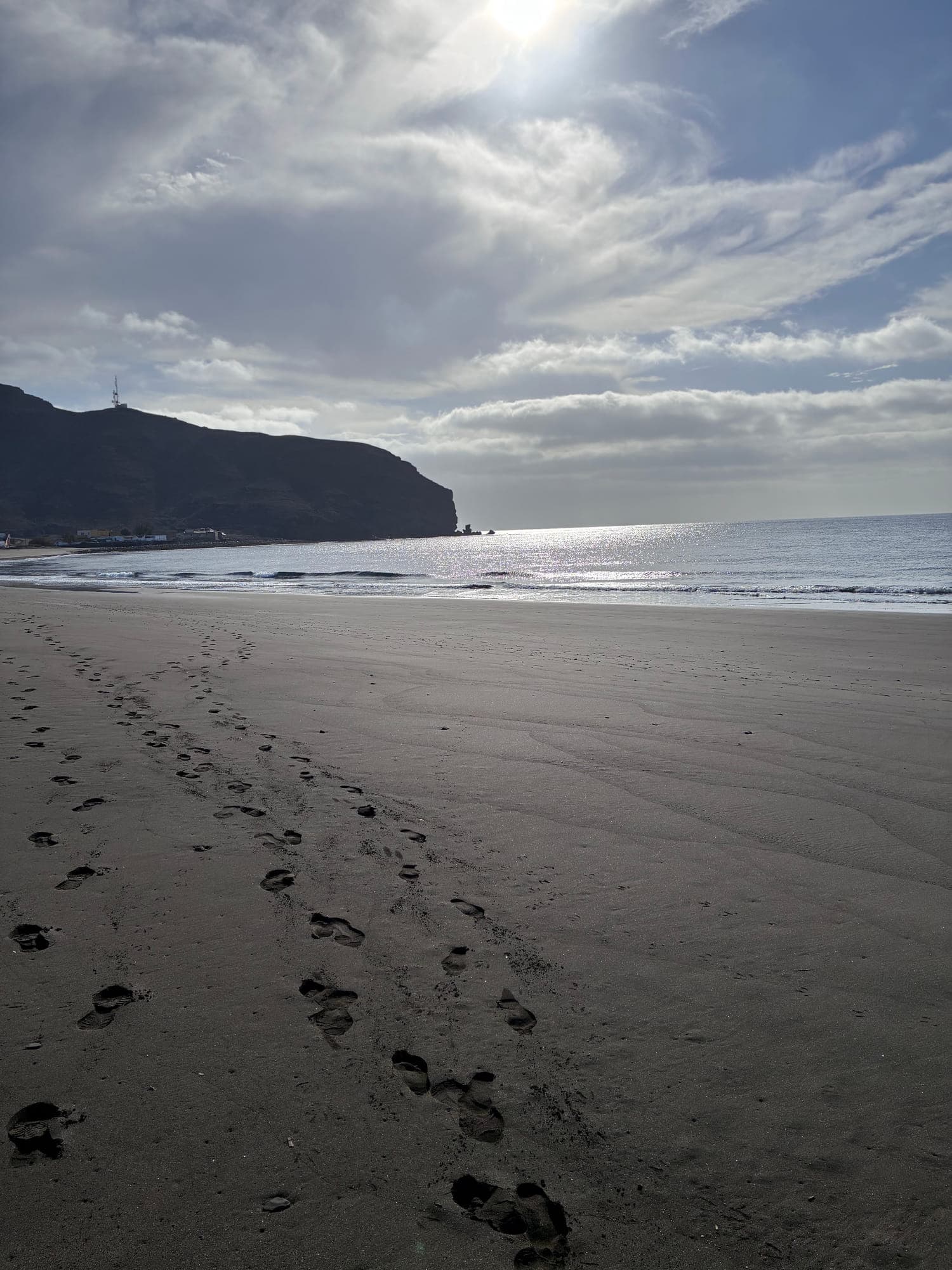 Footprints on the beach at sunset