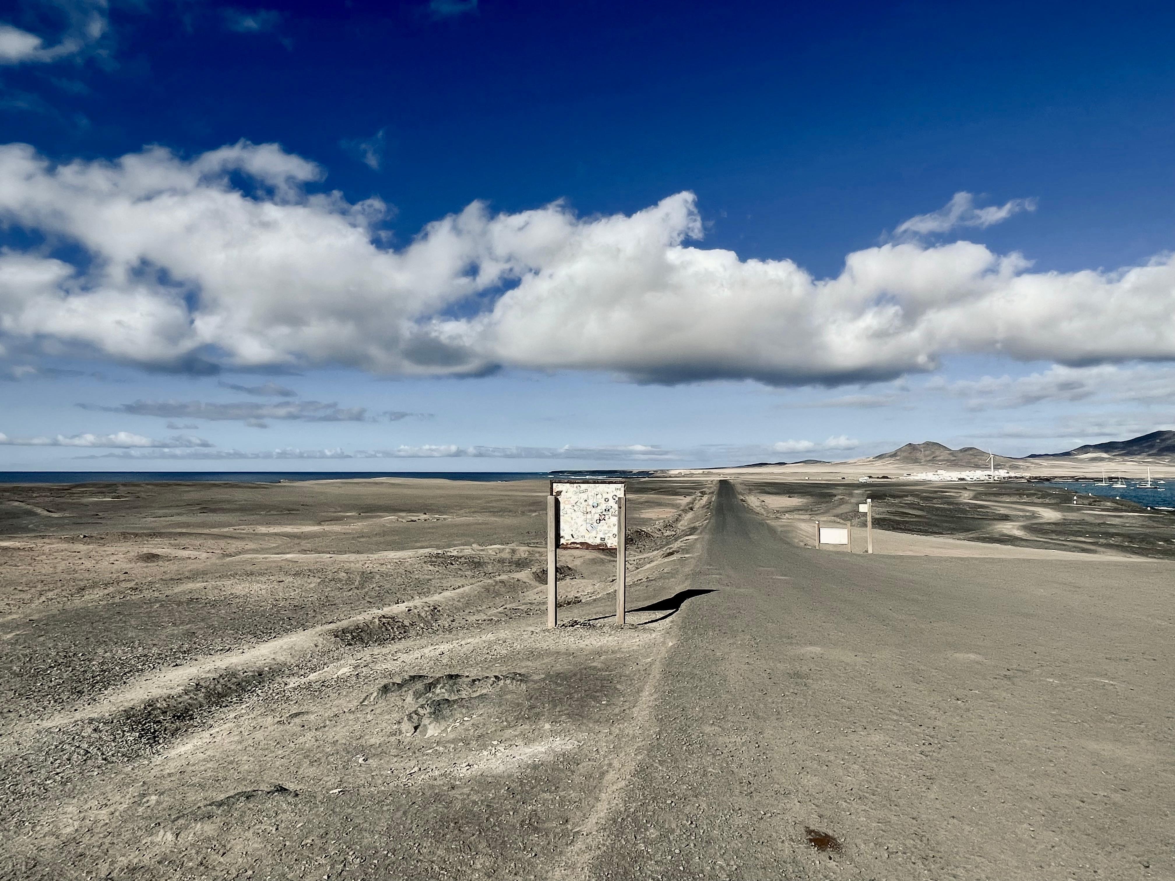 Desert road leading to the ocean