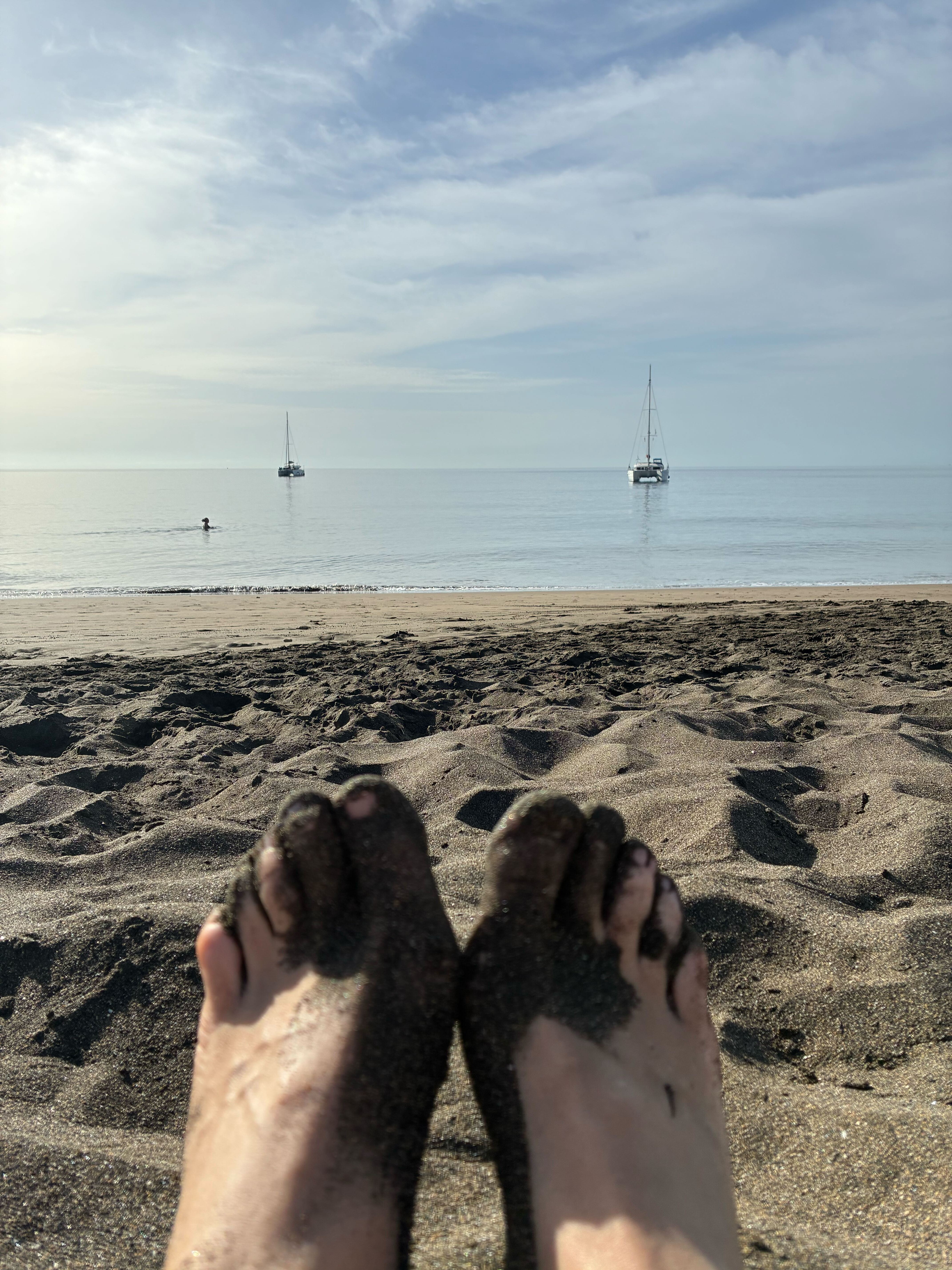 Relaxing on the beach with sailboats